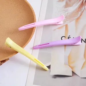 Professional hair styling duckbill clips in vibrant pastel colors, long design for salon use.