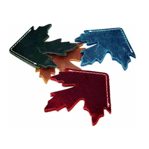 Close-up detail of handcrafted leather maple leaf corner bookmarks with neat white stitching.