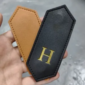 Leather magnetic bookmark set with stylish diamond shape and golden letter detail for reading.
