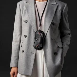 Detailed close-up of black leather neck-hanging glasses case worn by model for daily wear.