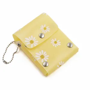 Yellow mini lipstick storage bag with cute daisy pattern, portable snap-button design.
