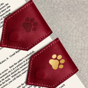 Close-up detail of leather magnetic bookmarks with cute paw print design for book reading.