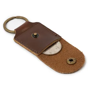 Portable leather guitar pick holder keychain with snap button and antique brass ring.