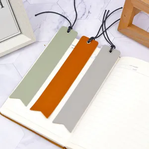 PU leather bookmark detail shot showing texture and colors on an open notebook page.