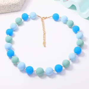 Close-up detail of the colorful macaron beaded necklace with pastel tones and metallic clasp.