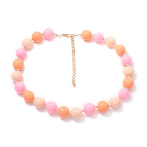 Detail shot of colorful macaron beaded necklace, sweet round beads close-up view.