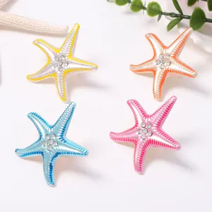 Close up detail view of colorful starfish adjustable rings with sparkling rhinestones, beach style.