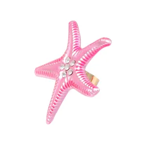 Pink rhinestone starfish ring close-up view, elegant ocean style detail of jewelry.