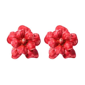 Closeup detail of elegant glossy red flower earrings featuring vibrant petals and gold pistil.