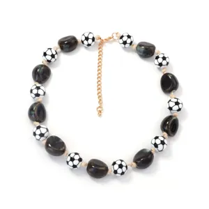 Dettaglio della collana di perle geometriche elegante con perline con motivo a pallone da calcio.
