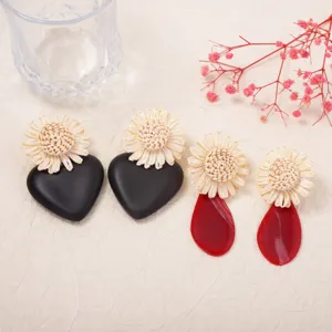 Boho raffia woven flower acrylic heart and teardrop statement earrings detail showcase.