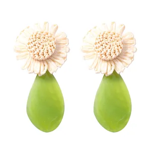 Chic raffia woven flower and green acrylic teardrop earrings for summer vacation style.