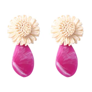 Rattan woven flower and pink acrylic teardrop statement earrings for summer vacation style.