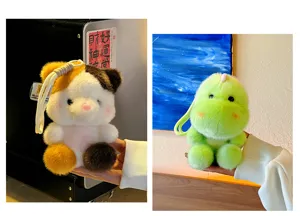 Cute plush animal keychain detail view, soft miniature cartoon backpack charm accessory.