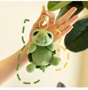 Cute green plush turtle keychain with gold hardware, soft stuffed animal bag pendant charm.