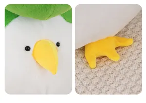 Cute plush toy detail view showing soft white fabric, yellow beak and green leaf decoration.
