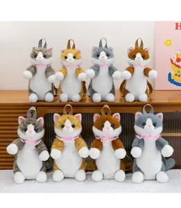 Close-up detail view of cute cartoon cat plush backpacks, soft furry material and sweet bow design.