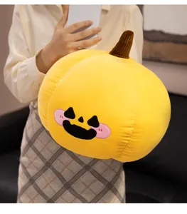 Close-up of cute Halloween plush pumpkin pillow with soft fabric and funny embroidered face.