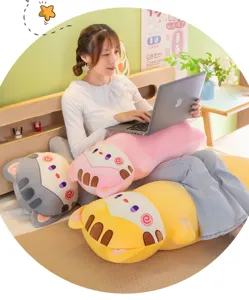 Cozy bedroom scene detail showing cute sleeping cat plush pillows in pink, yellow and grey.