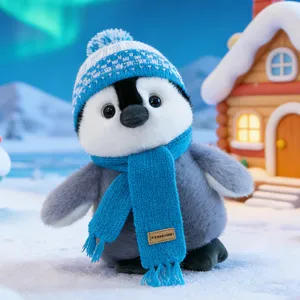Cute penguin plush toy wearing a warm winter hat and scarf, perfect desktop holiday gift decoration.
