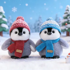 Cute penguin plush toy with winter hat and scarf, soft stuffed animal desktop ornament.