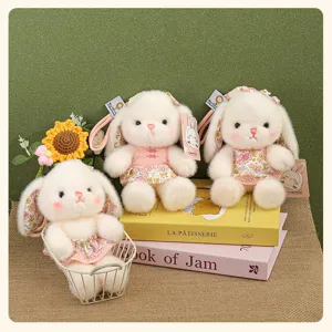 Gros plan sur le porte-clés lapin en peluche mignonne avec robe florale, compagnon de bureau.