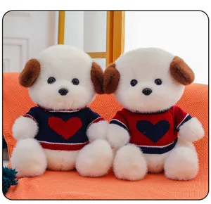 Cute couple puppy plush toys detail shot featuring soft white fur and sweet heart knit sweaters.