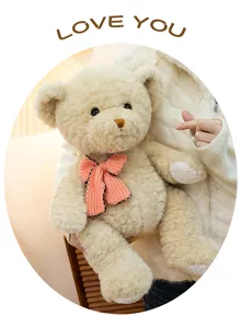 Cute plush teddy bear toy detail, soft beige stuffed animal with pink bow for cozy hugging.
