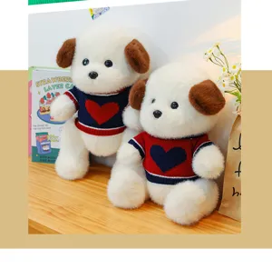 Detail shot of cute joint movable plush teddy dog toy with sweet heart sweater for home decor.