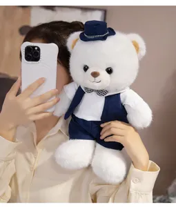 Cute white plush teddy bear doll with blue vest and hat, perfect romantic wedding gift.