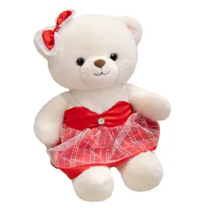 White teddy bear plush toy with red dress detail view, soft stuffed animal gift.