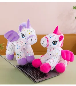 Detail shot of cute angel unicorn plush toy with colorful stars print and soft wings.