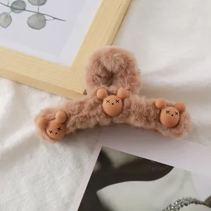 Fluffy brown plush hair claw clip with cute bear designs for women winter hair styling.