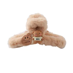 Fluffy plush hair claw clip for women, cute winter bear hair accessory styling tool.