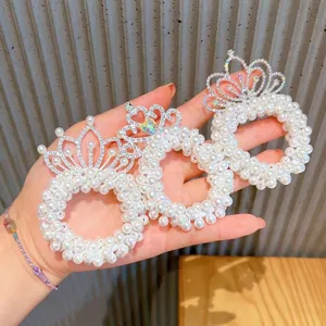 Detail shot of children pearl tiara hair scrunchies, sparkling rhinestone crown elastic bands.