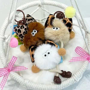 Cute fluffy plush doll keychain with leopard bow and big eyes, ideal bag charm and gift.