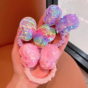 Détail des chouchous pour cheveux à sequins mignons pour enfants avec nœuds étincelants.
