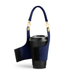 Close-up detail of the portable denim cup sleeve featuring sturdy gold metal clasps and handle.