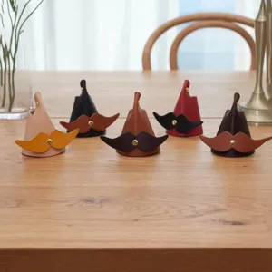 Detail shot of creative leather mustache eyeglass stands on a wooden table, stylish desktop decor.