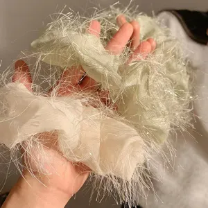 Primo piano dettagliato di elastici per capelli in tinsel scintillante, consistenza morbida e frange.