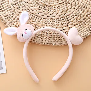 Close-up detail of cute pink plush bunny headband with sweet heart accessory for autumn.