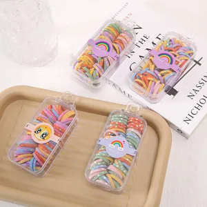 Colorful elastic hair ties for kids in transparent boxes, cute hair accessory details.