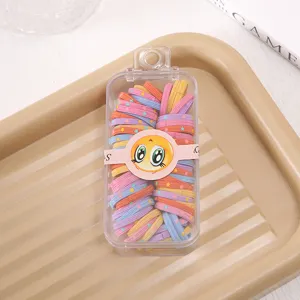 Detailed view of colorful elastic hair ties with star patterns in a clear storage box.