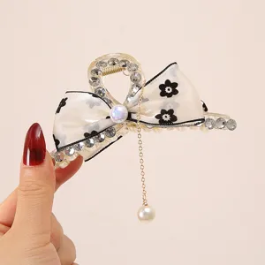 Elegant organza bow hair claw clip with rhinestones, pearls and a delicate tassel chain.