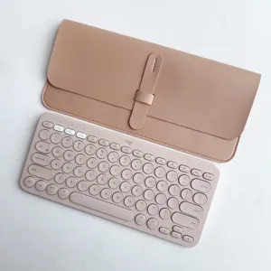 Detailed view of wireless keyboard and matching leather protective sleeve in pink.