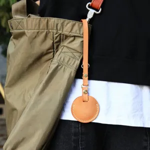 Portable PU leather round tracker case keychain accessory with sturdy metal clasp and strap.