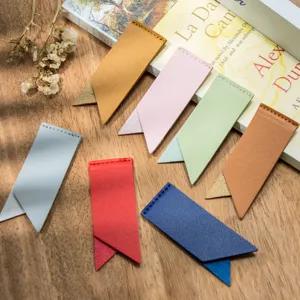 Close-up detail of colorful PU leather bookmarks, stylish clipping design on wooden desk.