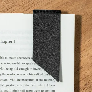 Black leather corner page bookmark detail view, elegant reading accessory for books.