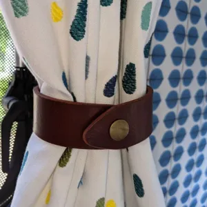 Brown PU leather curtain tieback detail, punch free curtain buckle strap for home decor.