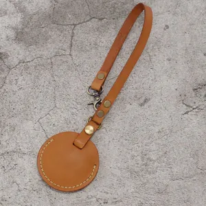 PU leather key ring strap brown round car key cover holder portable accessory for daily use.